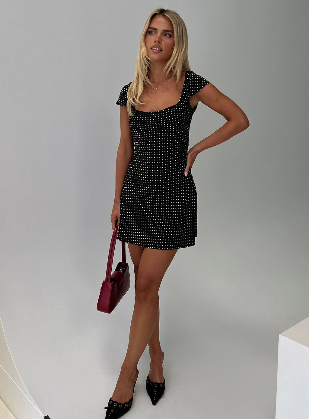 side view of model wearing Princess Polly Lucienna Polka Dot Mini Dress Black / White Square Neck 